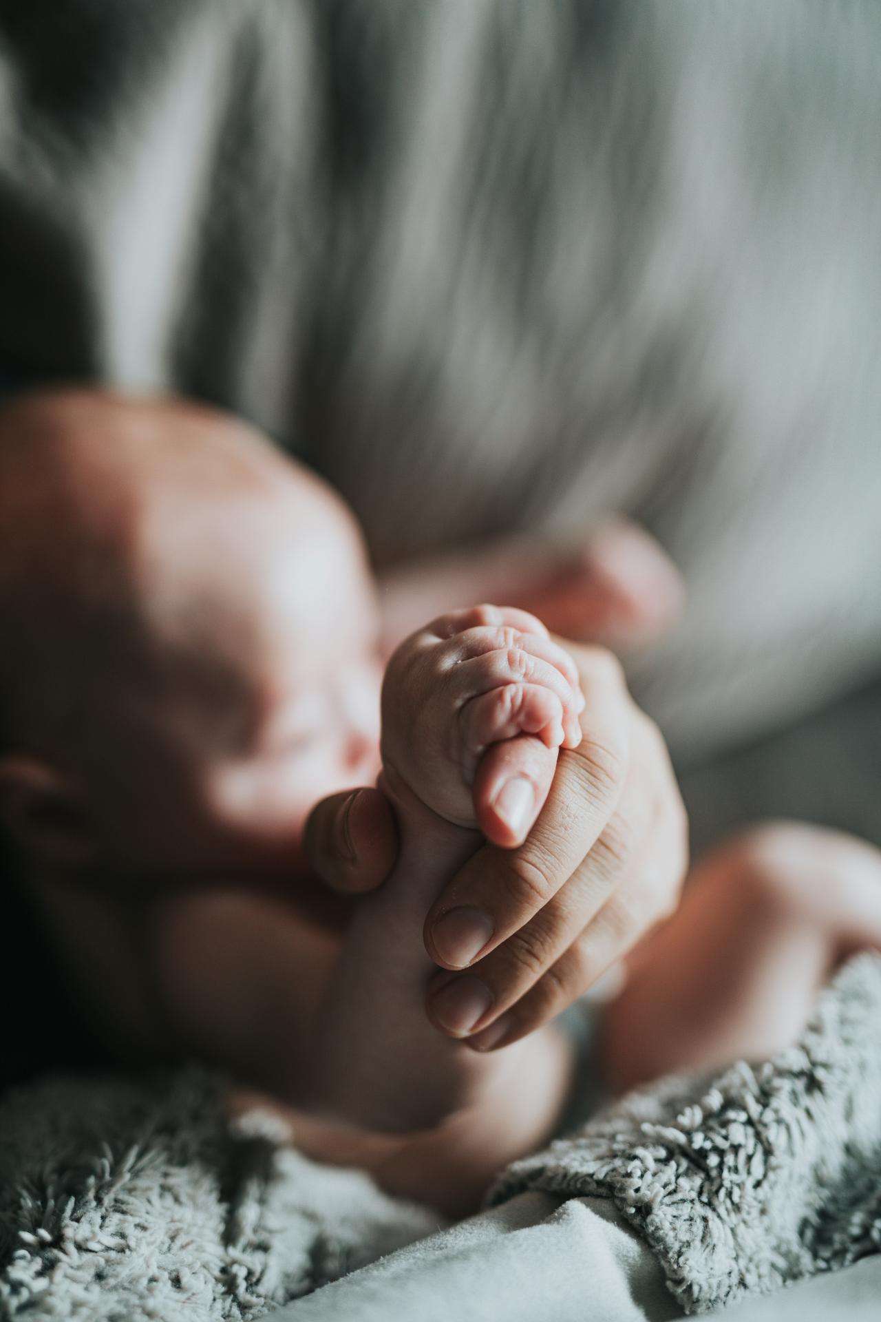 Baby held by parent symbolising the unique dosha combination we are born with in Ayurveda, explaining personal constitution and balance