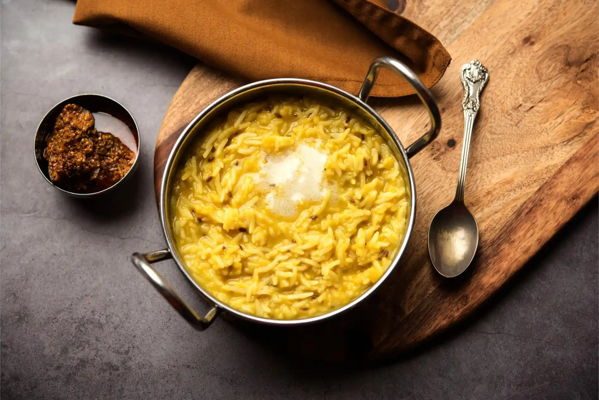 Indian-style bowl of kitchari with rice, yellow mung dal, ghee, and digestive spices, symbolising the Essential Reset package for digestive health.
