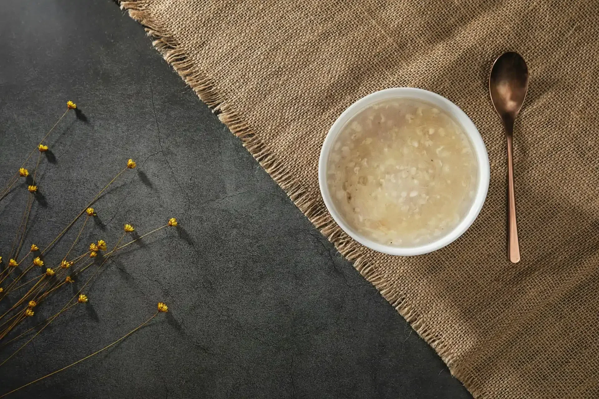 Bowl of rice porridge with a spoon, representing a light and nourishing breakfast for gentle digestive support during the 5-Day Digestive Reset.
