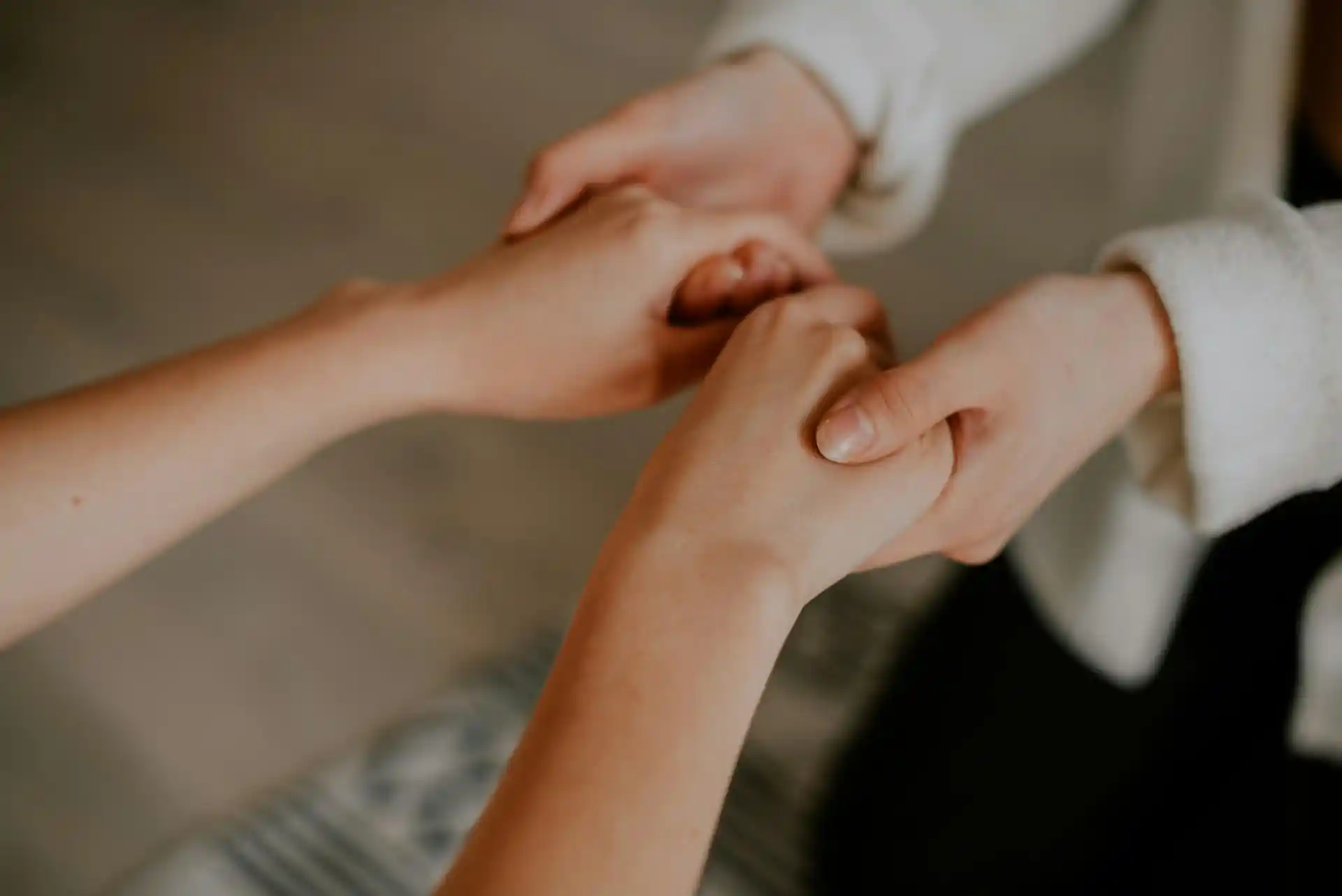Two people holding hands, representing guidance and support during the 5-Day Digestive Reset.