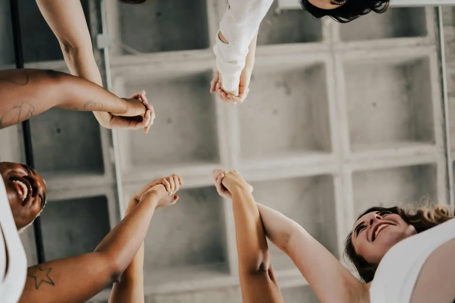 Group of people holding hands, representing community and support during the 5-Day Digestive Reset.